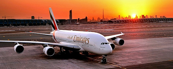Emirates airplane on the tarmac at sunset